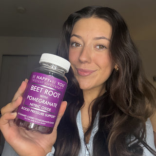 Person holding a bottle of 'Be Happy Be You' beet root supplement